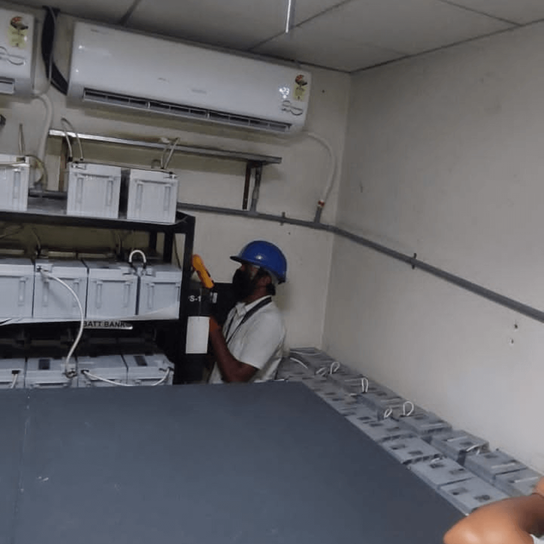 Worker checking UPS batteries
